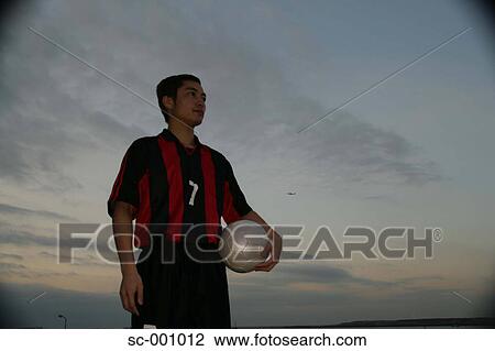 Soccer player under evening sky View Large Photo Image Stock Image - Soccer player under evening sky. Fotosearch