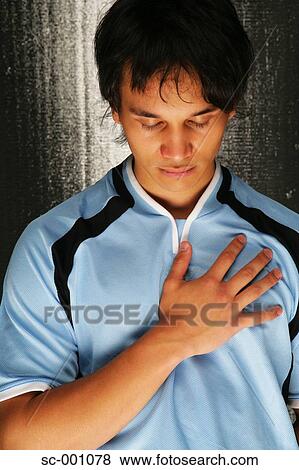 Soccer player with hand on heart View Large Photo Image Stock Photo - Soccer player with hand on heart. Fotosearch