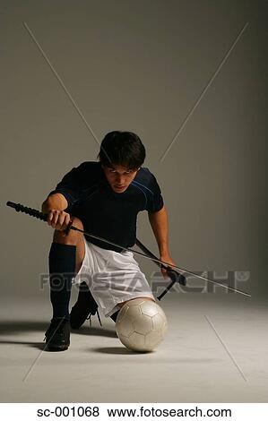 Stock Photo - Soccer player with Japanese sword. Fotosearch