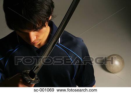 Stock Photo - Soccer player with Japanese sword. Fotosearch