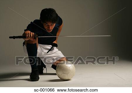 Soccer player with Japanese sword View Large Photo Image Stock Photograph - Soccer player with Japanese sword. Fotosearch
