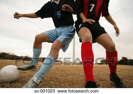 Stock Image - Two soccer players challenging for ball. Fotosearch