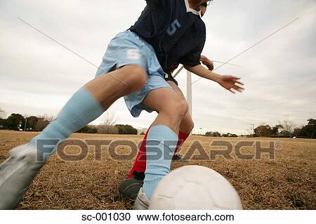 Stock Image - Two soccer players challenging for ball. Fotosearch