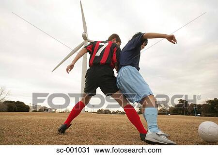 Stock Image - Two soccer players challenging for ball. Fotosearch