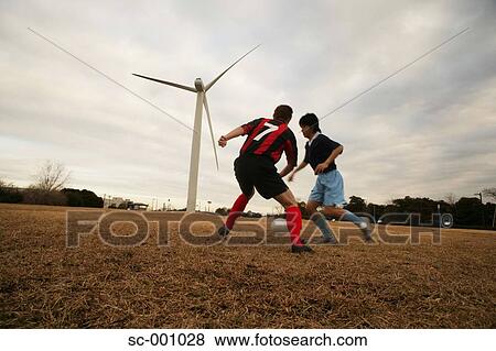 Two soccer players challenging for ball View Large Photo Image Stock Photo - Two soccer players challenging for ball. Fotosearch