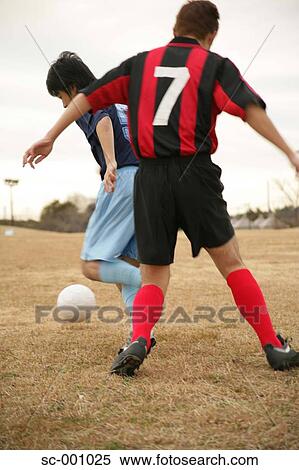 Two soccer players challenging for ball View Large Photo Image Stock Photography - Two soccer players challenging for ball. Fotosearch
