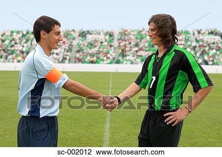 Opposing captains shaking hands View Large Photo Image Stock Image - Opposing captains shaking hands. Fotosearch