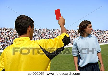 Referee showing red card to disappointed player View Large Photo Image Stock Image - Referee showing red card to disappointed player. Fotosearch