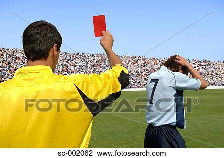 Referee showing red card to disappointed player View Large Photo Image Stock Image - Referee showing red card to disappointed player. Fotosearch