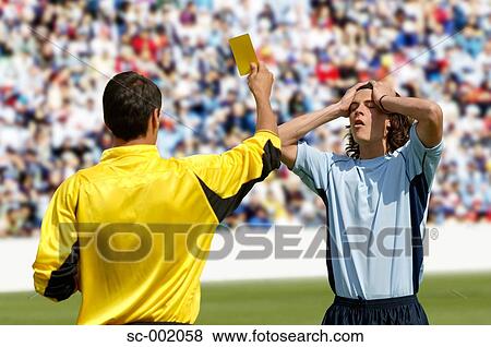 Referee showing yellow card to disappointed player View Large Photo Image Stock Photo - Referee showing yellow card to disappointed player. Fotosearch