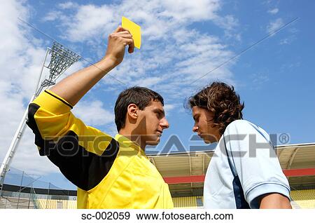 Referee showing yellow card to disappointed player View Large Photo Image Stock Photo - Referee showing yellow card to disappointed player. Fotosearch