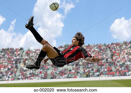 Soccer player doing scissor-kick View Large Photo Image Stock Image - Soccer player doing scissor-kick. Fotosearch