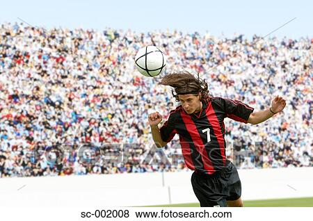 Stock Photo - Soccer player heading ball. Fotosearch