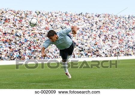 Stock Photo - Soccer player heading ball. Fotosearch