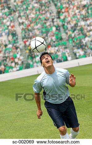 Soccer player juggling ball on head View Large Photo Image Stock Photo - Soccer player juggling ball on head. Fotosearch