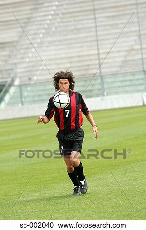 Stock Image - Soccer player juggling ball. Fotosearch