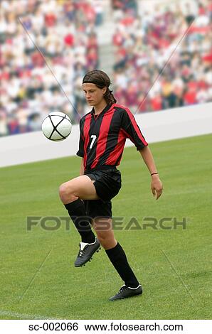 Soccer player juggling ball View Large Photo Image Stock Photograph - Soccer player juggling ball. Fotosearch