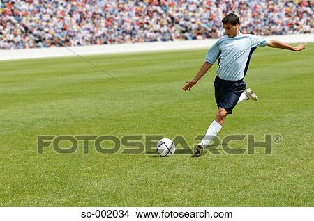 Soccer player striking ball View Large Photo Image Picture - Soccer player striking ball. Fotosearch