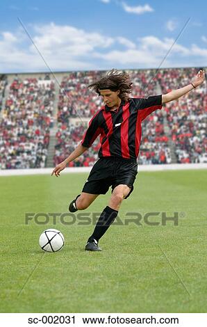 Soccer player striking ball View Large Photo Image Stock Image - Soccer player striking ball. Fotosearch