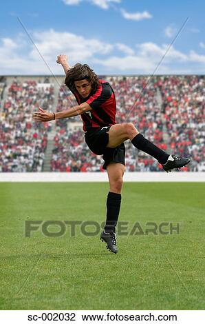 Soccer player striking ball View Large Photo Image Stock Image - Soccer player striking ball. Fotosearch