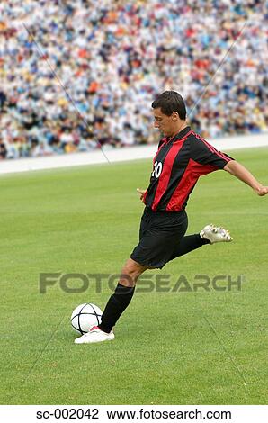Soccer player striking ball View Large Photo Image Stock Image - Soccer player striking ball. Fotosearch