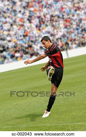 Soccer player striking ball View Large Photo Image Stock Image - Soccer player striking ball. Fotosearch