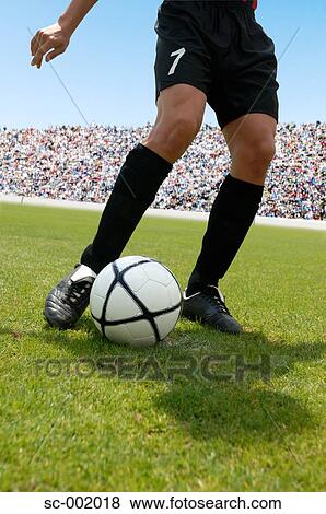 Soccer player striking ball View Large Photo Image Stock Photo - Soccer player striking ball. Fotosearch