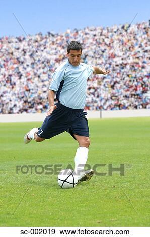Stock Photo - Soccer player striking ball. Fotosearch