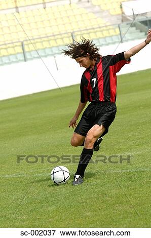 Soccer player striking ball View Large Photo Image Stock Photo - Soccer player striking ball. Fotosearch