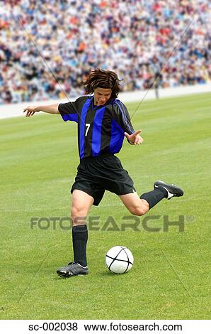 Soccer player striking ball View Large Photo Image Stock Photo - Soccer player striking ball. Fotosearch
