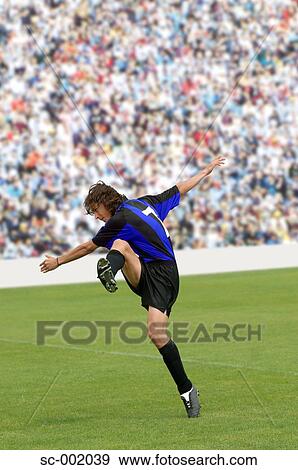 Soccer player striking ball View Large Photo Image Stock Photo - Soccer player striking ball. Fotosearch