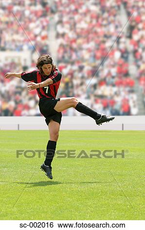 Stock Photograph - Soccer player striking ball. Fotosearch