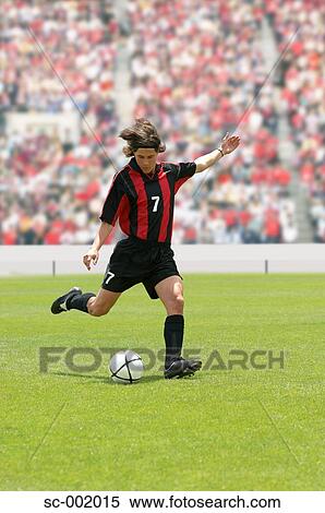 Stock Photography - Soccer player striking ball. Fotosearch
