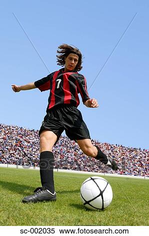 Soccer player striking ball View Large Photo Image Stock Photography - Soccer player striking ball. Fotosearch