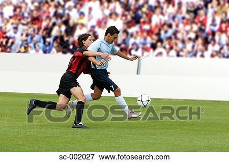 Soccer players battling for ball View Large Photo Image Stock Photo - Soccer players battling for ball. Fotosearch