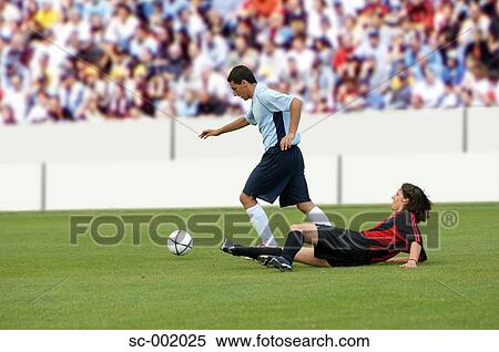 Soccer players battling for ball View Large Photo Image Stock Photography - Soccer players battling for ball. Fotosearch