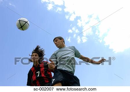 Stock Photo - Soccer players jumping for the ball. Fotosearch