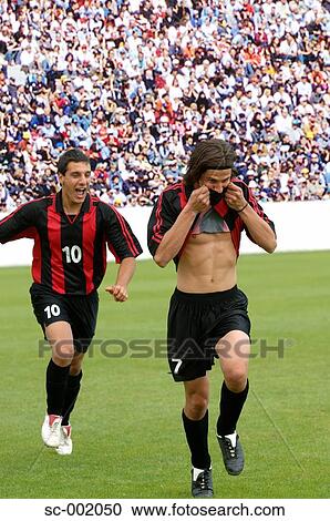 Two teammates celebrating View Large Photo Image Stock Image - Two teammates celebrating. Fotosearch