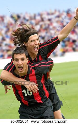 Stock Image - Two teammates celebrating. Fotosearch