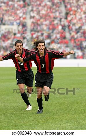 Two teammates celebrating View Large Photo Image Stock Photo - Two teammates celebrating. Fotosearch