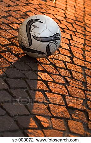 Stock Image - Ball on cobbled stone street. Fotosearch