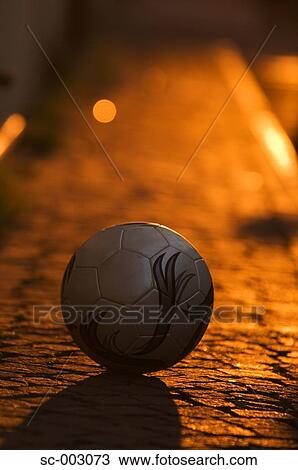 Stock Image - Ball on cobbled stone street. Fotosearch