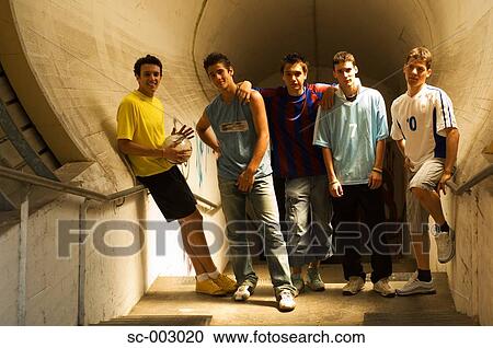 Stock Image - Group of teenage soccer friends in tunnel. Fotosearch