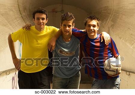 Stock Image - Group of teenage soccer friends in tunnel. Fotosearch
