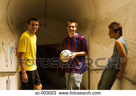 Stock Image - Group of teenage soccer friends in tunnel. Fotosearch