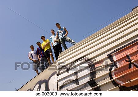 Stock Image - Group of teenage soccer friends on roof of tunnel. Fotosearch