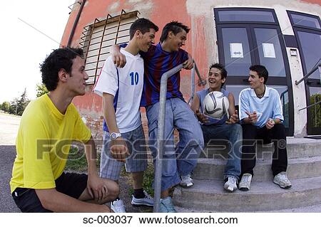 Stock Photo - Group of teenage soccer friends on steps. Fotosearch