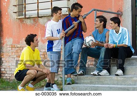 Stock Photography - Group of teenage soccer friends on steps. Fotosearch
