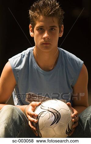 Stock Photo - Portrait of teenage boy with soccer ball. Fotosearch