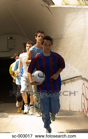 Stock Photo - Street soccer team emerging from tunnel. Fotosearch